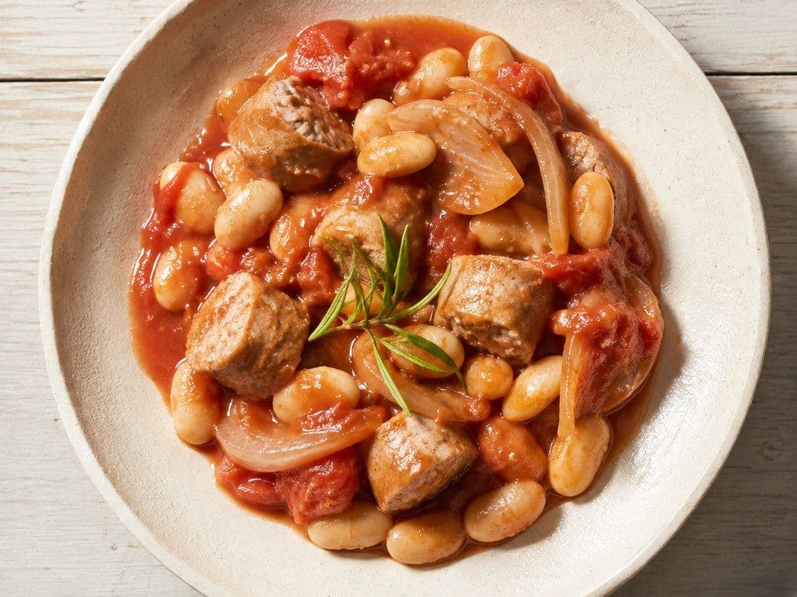 Sausage and butterbean casserole, plated as one serving.