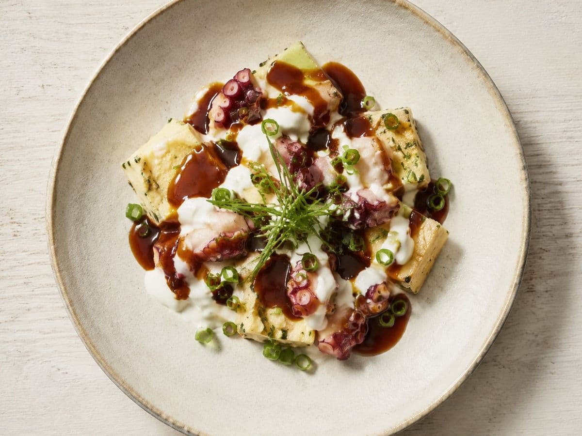Takoyaki, plated as one serving.