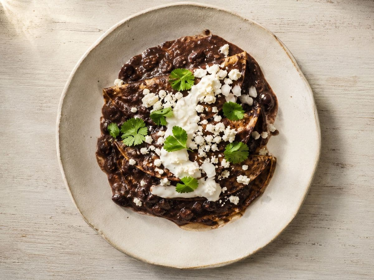 Enfrijoladas, plated as one serving.