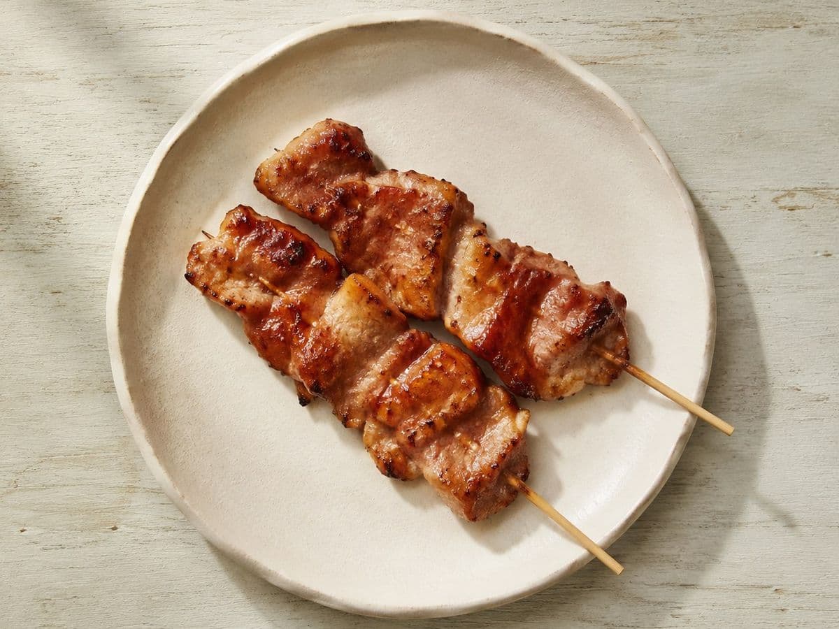 Moo Ping (Pork Skewers), plated as one serving.